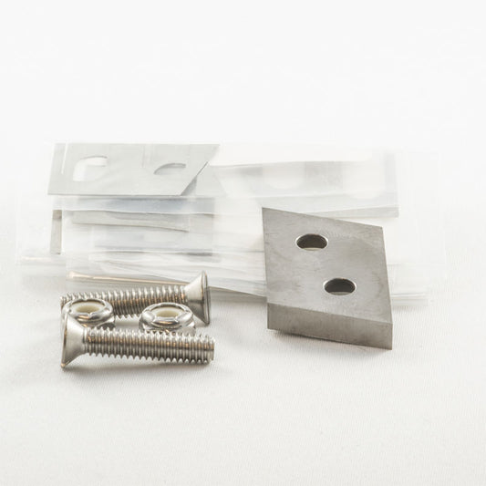 metal screws, washers and metal blade stacked together on a white background.